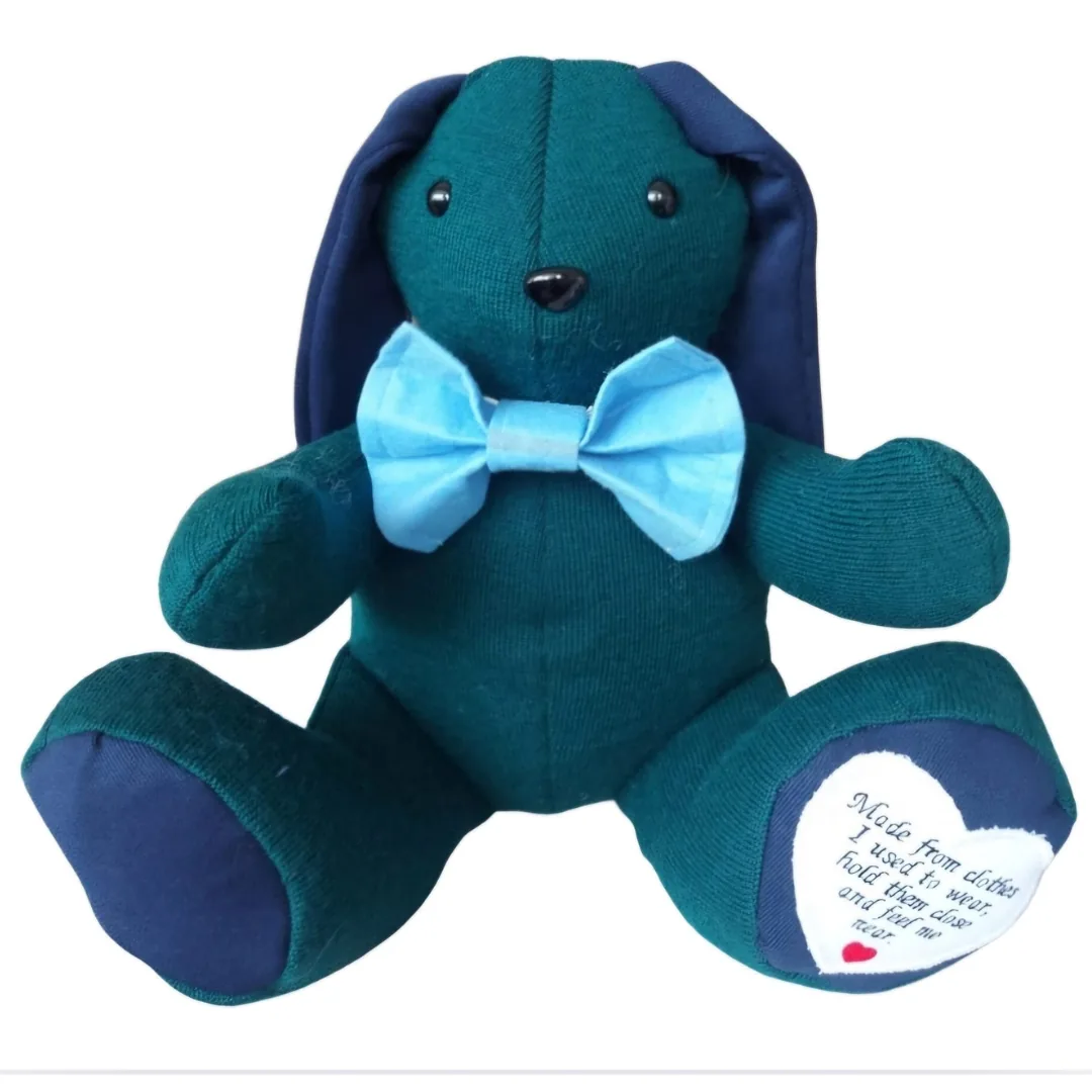 Voice box memory bunny made from deep green fabric with navy ears and paw pads, a pale blue dicky bow and an embroidered heart poem