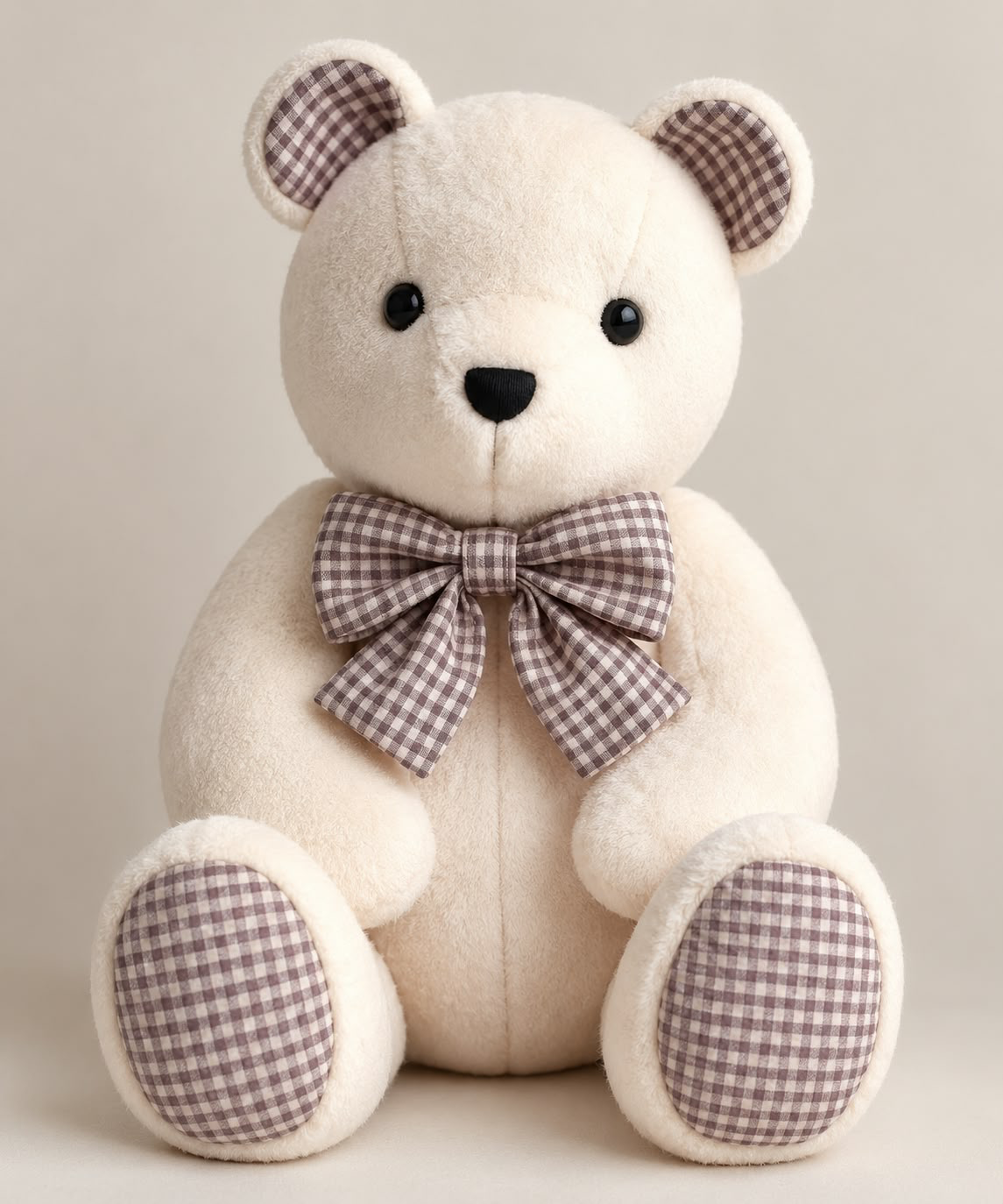 New style memory bear made from cream plush with brown gingham ears, paw pads and a large matching bow tie