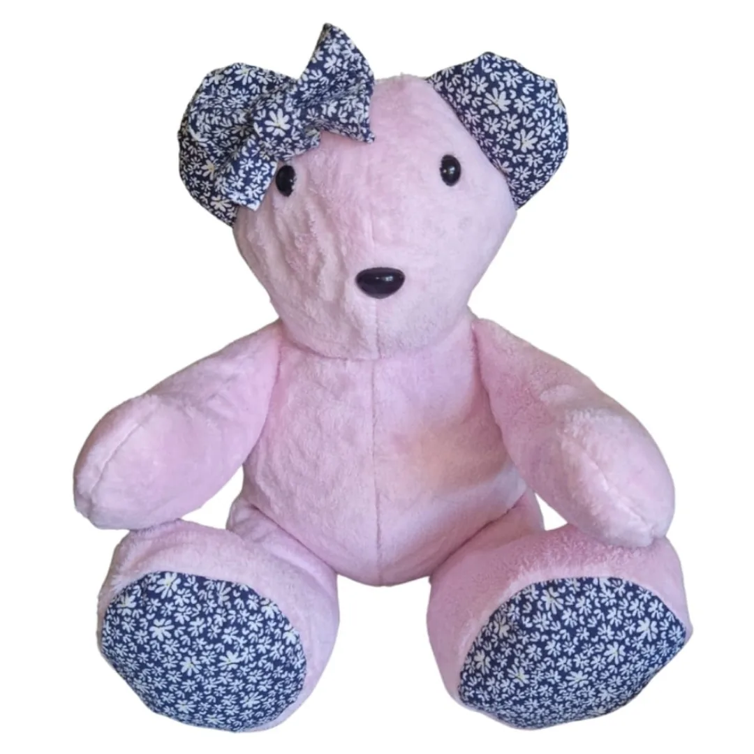 Pink ashes bear with navy floral ears, paw pads and a large floral bow, sitting up