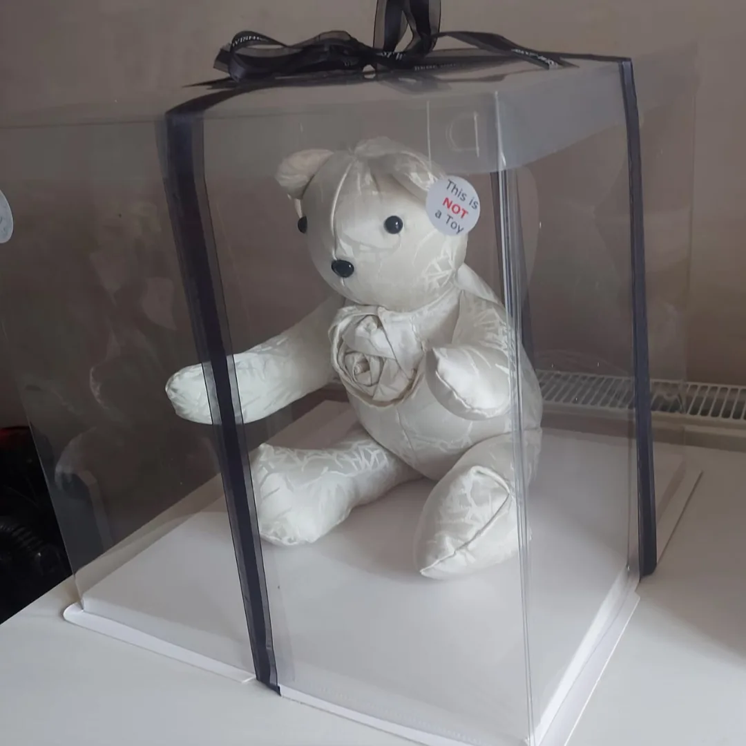 Ivory wedding dress memory bear in a clear gift box tied with a black ribbon